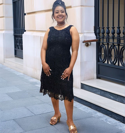 Black lace sleeveless evening dress with fitted bodice and lace scallop hem