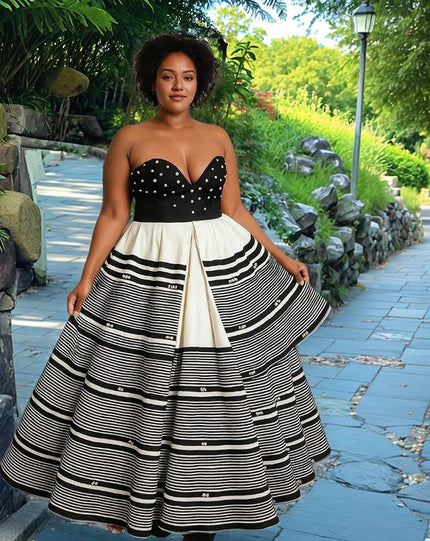 Strapless patchwork maxi dress with black corset bodice and striped layered skirt.