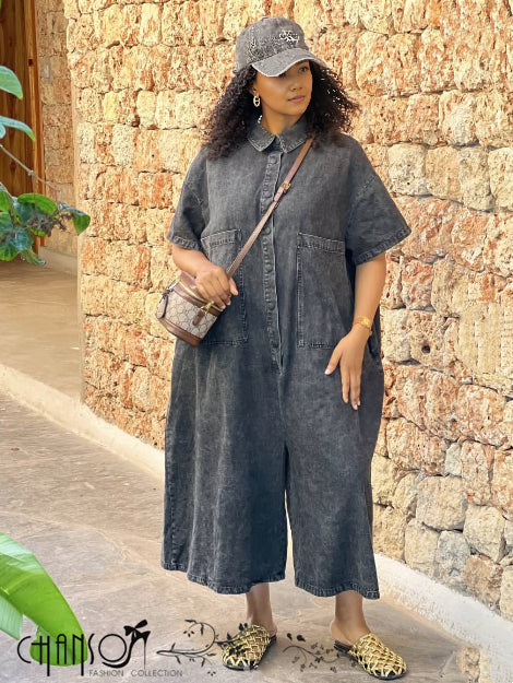 Dark denim loose-fit button-front jumpsuit with short sleeves and wide-leg pant legs