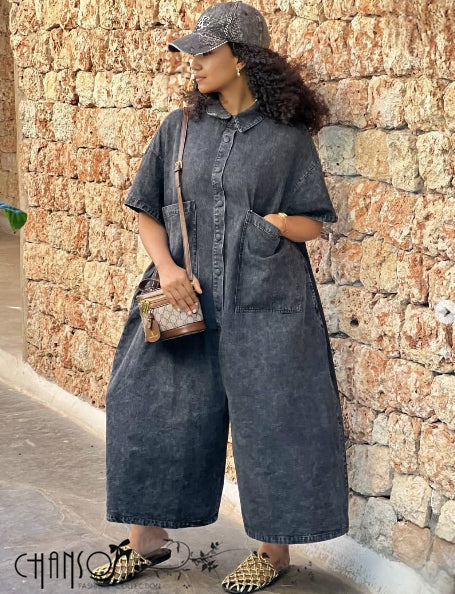 Dark denim loose-fit button-front jumpsuit with large front pockets and wide legs