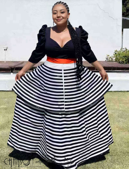 Black striped maxi dress with puff sleeves, V-neck bodice, and tiered skirt