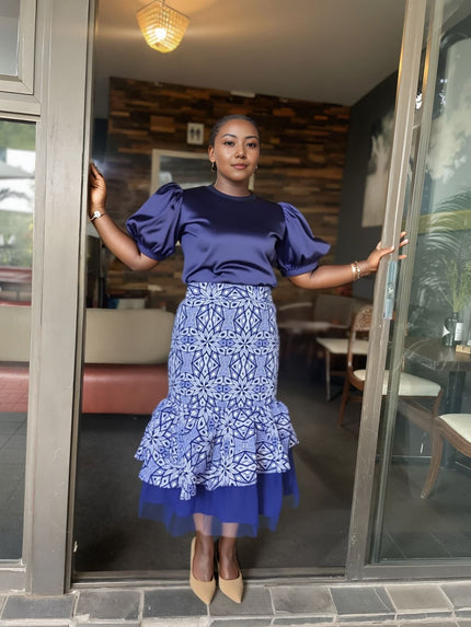 Layered skirt and puff-sleeve blouse set: navy blouse, blue patterned peplum skirt with tulle