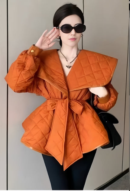 Orange puffy belted jacket with diamond quilting, wide collar and long sleeves