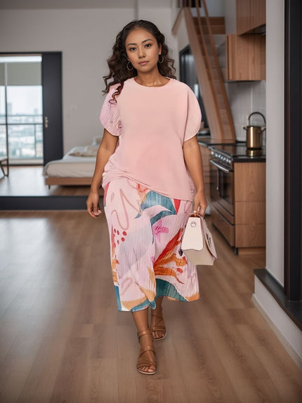 Pleated abstract-print midi skirt with colorful shapes, worn with a pink top