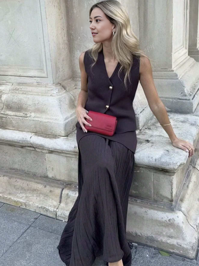Dark pleated midi skirt with matching sleeveless vest, gold button front and V neckline