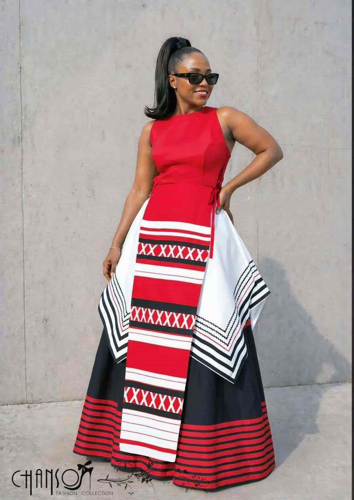 Red sleeveless maxi dress with layered striped hem in black, white, and red