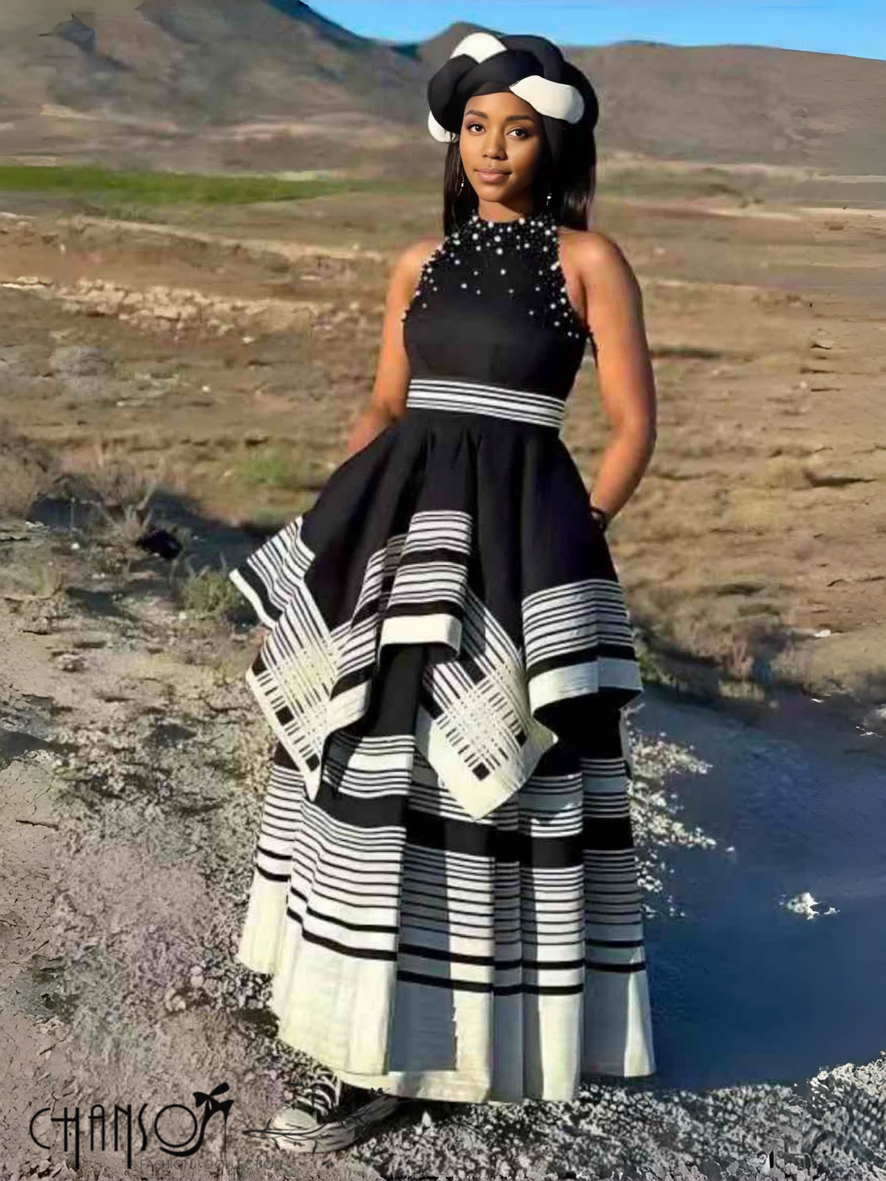 Black beaded maxi dress with sleeveless high collar and layered striped skirt