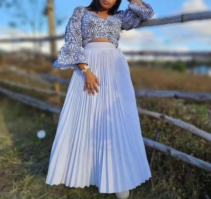 Light blue pleated maxi skirt with gathered waist and wide A-line silhouette