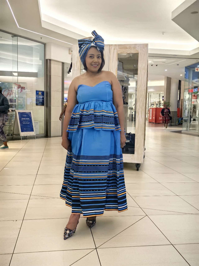 Strapless tiered dress with navy-and-yellow striped hem and matching striped headwrap