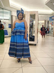 Strapless light-blue maxi dress with striped tiers and navy headwrap