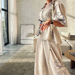 Cream blouse and wide-leg pants set with floral line-art embroidery and drawstring waist