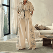 Cream wide-leg pant set with puff sleeves, tie waist blouse and floral embroidery