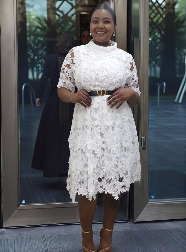 White lace evening dress with belted waist and short lace sleeves, scalloped hem