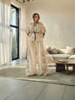 Cream wide-leg pants twin set with puff sleeves, tie-waist blouse and floral embroidery