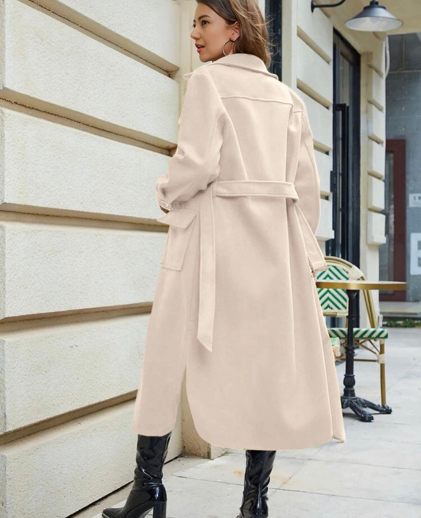 Beige belted knee-length trench coat with tie belt and flap pockets
