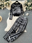 Botanical printed two-piece set: black long-sleeve top and wide-leg pants with white contrast trim