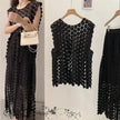 Black geometric patterned sleeveless top with layered skirt, twin set