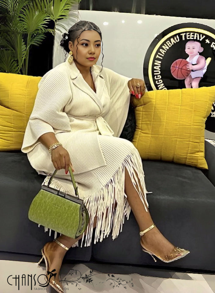 Beige pleated twin set with V-neck top and matching fringe skirt, belted waist