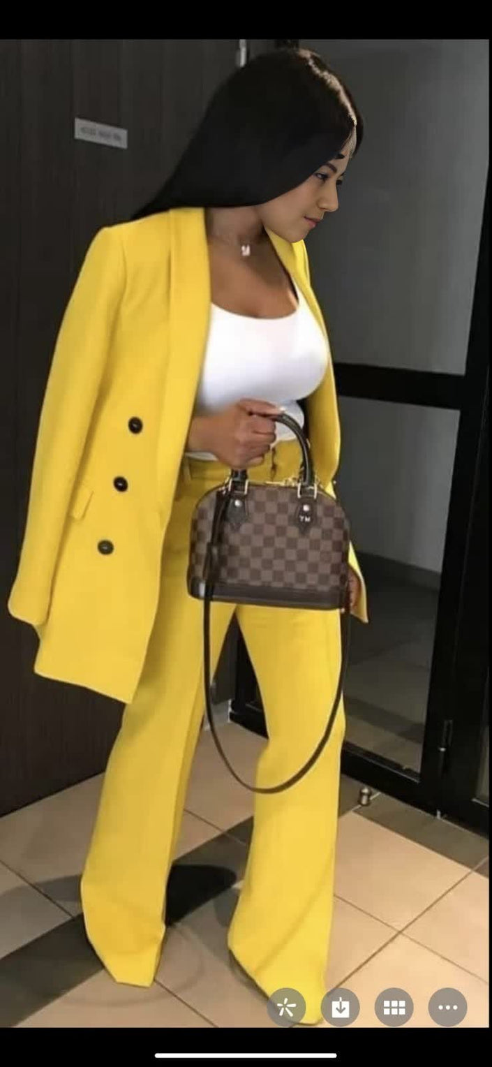 Yellow double-breasted blazer suit with matching trousers and black buttons