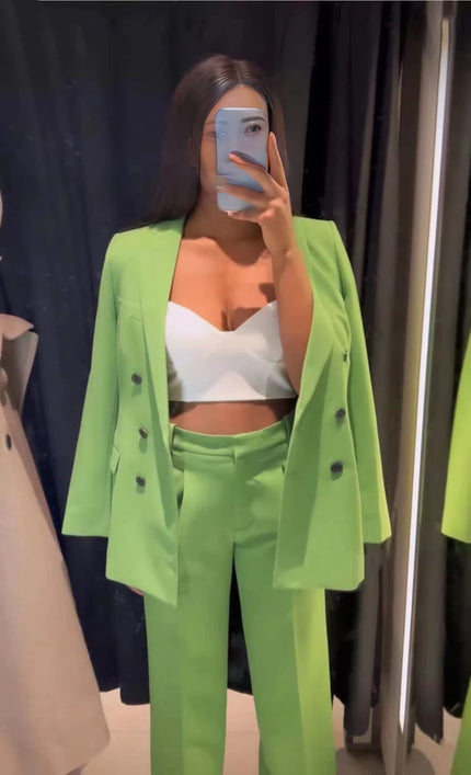 Green double-breasted blazer suit with matching trousers and black buttons