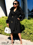 Black belted coat with fur-trimmed collar and cuffs, gold buttons, tie waist.