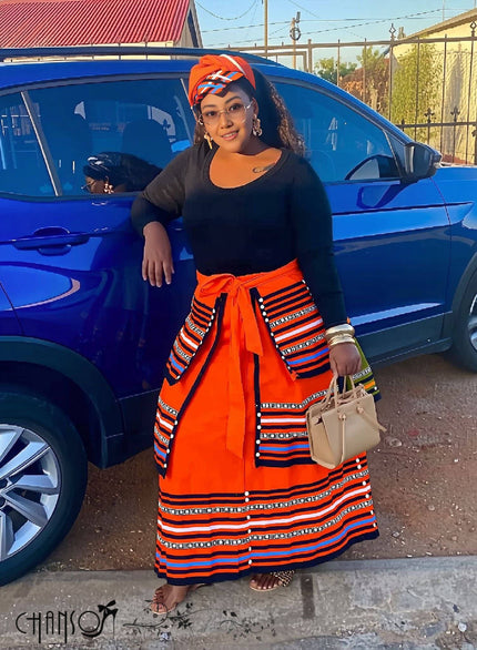 African maxi skirt set: black top with orange striped maxi skirt and tied waist sash