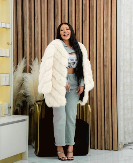 White plush fur coat with puffy sleeves, open front, mid-length.