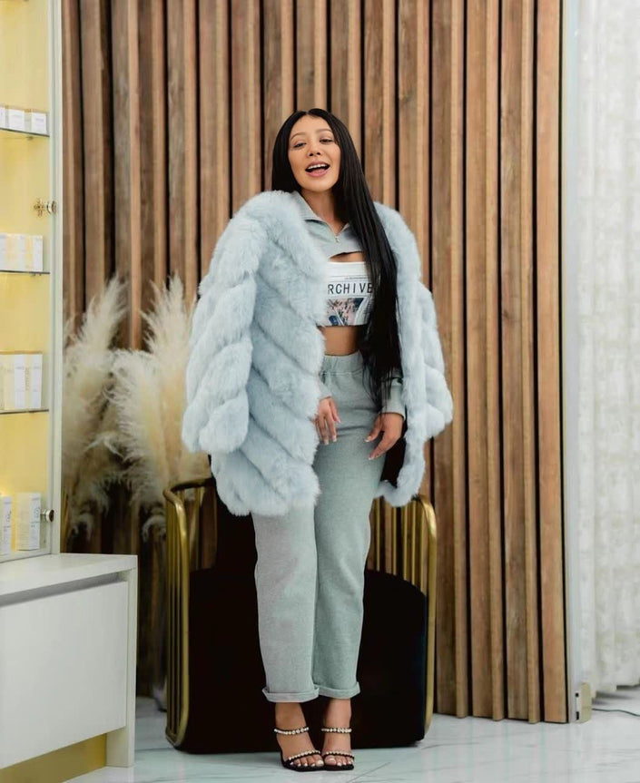 Light-cyan plush fur coat with puffy sleeves, open front, mid-length.