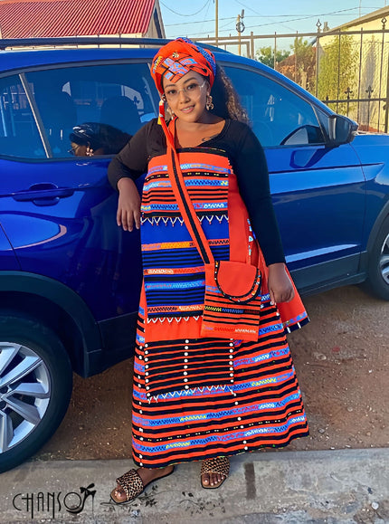 Geometric print maxi skirt set, orange/blue striped skirt and black top, side view