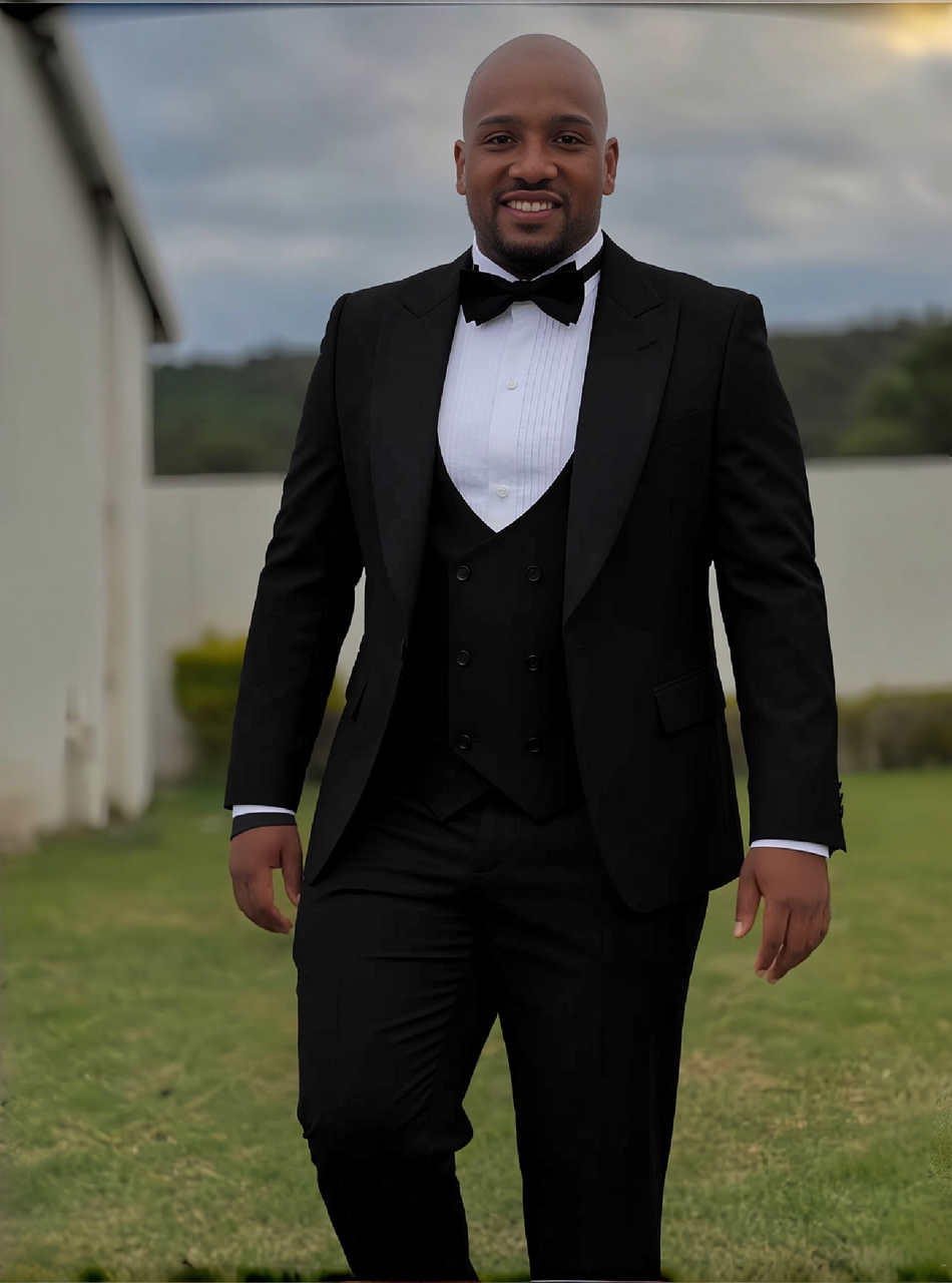 Men's black three-piece tuxedo suit with shawl lapels, white shirt, and bow tie
