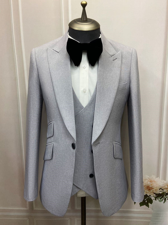 Modern fit suit set blazer with notched lapels, matching vest, and black bow tie
