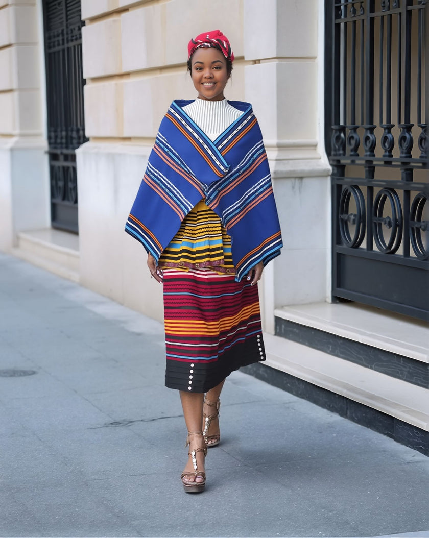 5-piece striped skirt set with blue cape-style layer over white top and patterned skirt