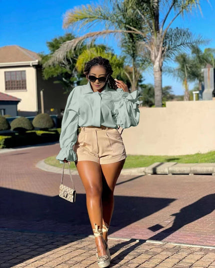 High-neck puff-sleeve blouse in light green with ruffled cuffs and gathered shoulders
