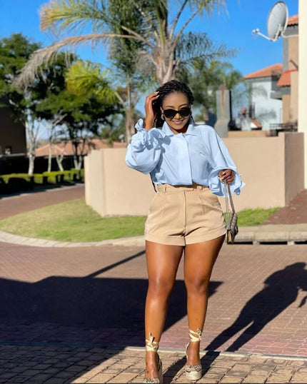 High-neck puff-sleeve blouse in light blue with ruffled cuffs and gathered shoulders