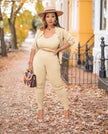 Beige knit three-piece set with cropped top, cardigan, and fitted capri pants