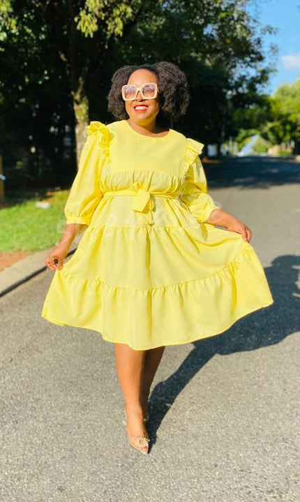 Yellow midi ruffle-tier dress with loose fit and bow detail at waist