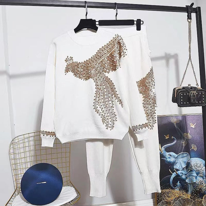 White knit twin set with gold sequin bird motif on long-sleeve top and pants