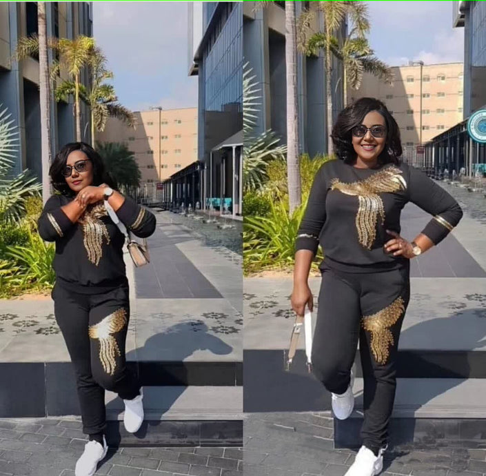 Black knit twin set with gold sequin bird motif on long-sleeve top and pants