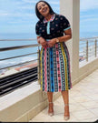 Pleated African print midi skirt with colorful vertical stripe pattern on dark base
