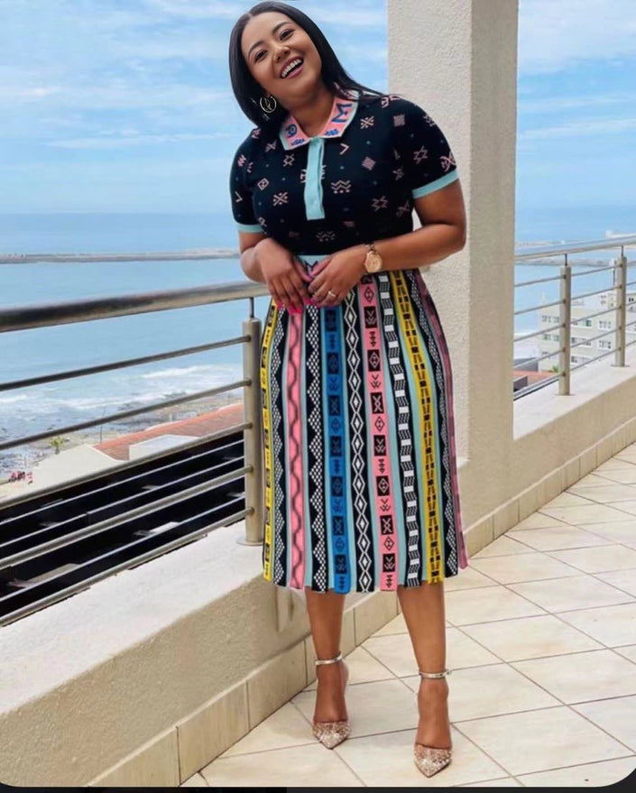 Pleated African print midi skirt with colorful vertical stripe pattern on dark base