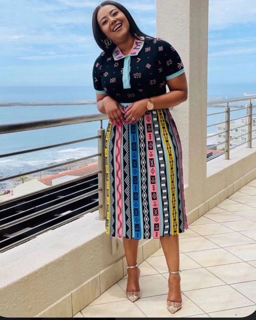 Pleated African print midi skirt with colorful vertical stripe pattern on dark base