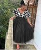 Black tiered tulle maxi dress with puff sleeves and V-neck patterned trim