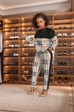 Plaid twin set outfit with black long-sleeve top and matching plaid trousers