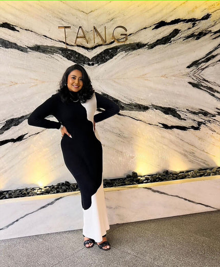 Dual-tone winter maxi dress with black fitted bodice, long sleeves, white hem