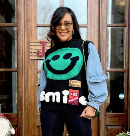 Black knit top with turquoise smiley face and layered denim sleeves, crew neck