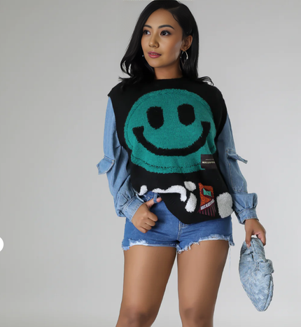 Black knit smiley face sweater vest with long denim sleeves