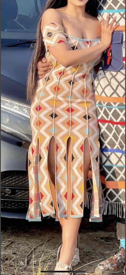 Off-shoulder geometric midi dress, beige with red and blue pattern, fringe hem