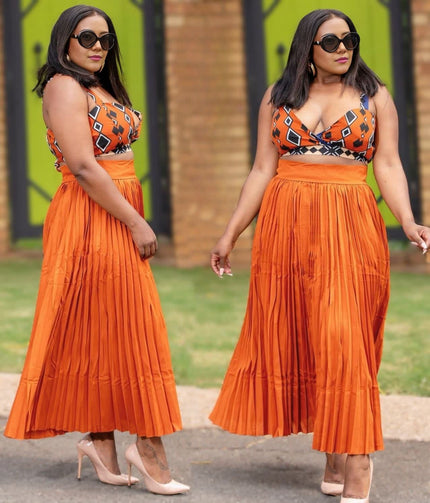 Orange geometric print sleeveless top with pleated midi skirt
