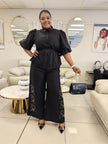 Black puff-sleeve twin set with tied waist blouse and floral-embroidered wide-leg pants