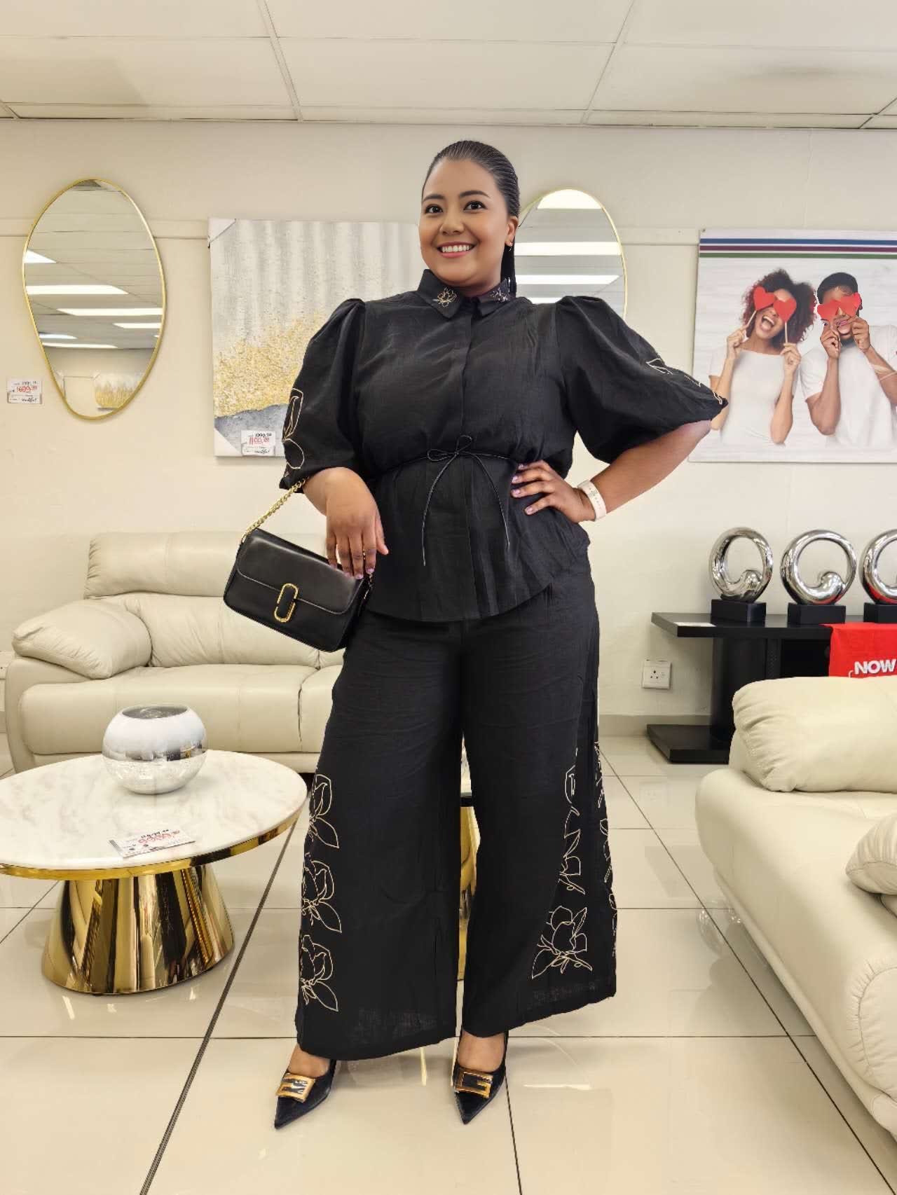 Black puff-sleeve twin set with floral embroidery wide-leg pants, cinched waist blouse